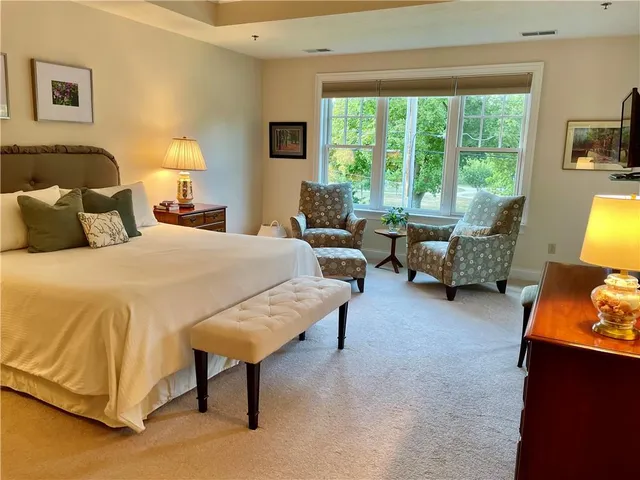 a spacious bedroom with a bed and a couch