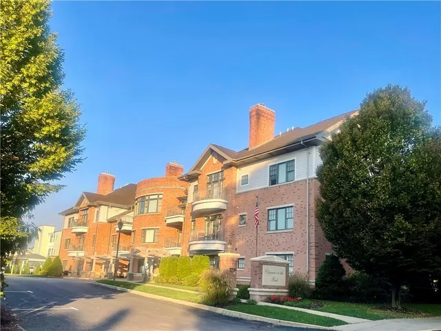a living room with furniture a flat screen tv and a window