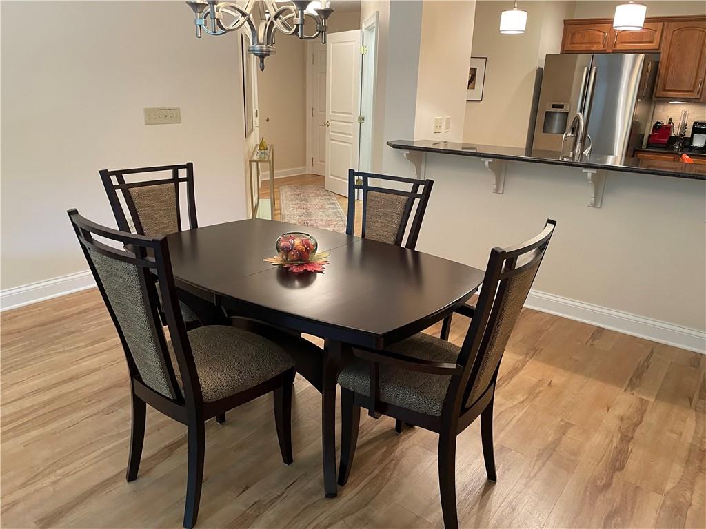 295 Market Street, Unit 123 Beaver, PA 15009 - Photo 26 of 27 a view of a dining room with furniture and wooden floor