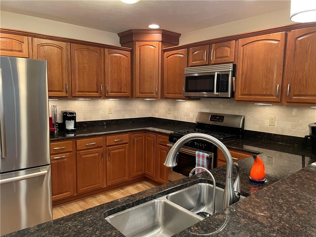 295 Market Street, Unit 123 Beaver, PA 15009 - Photo 7 of 27 a kitchen with stainless steel appliances granite countertop a sink refrigerator and microwave