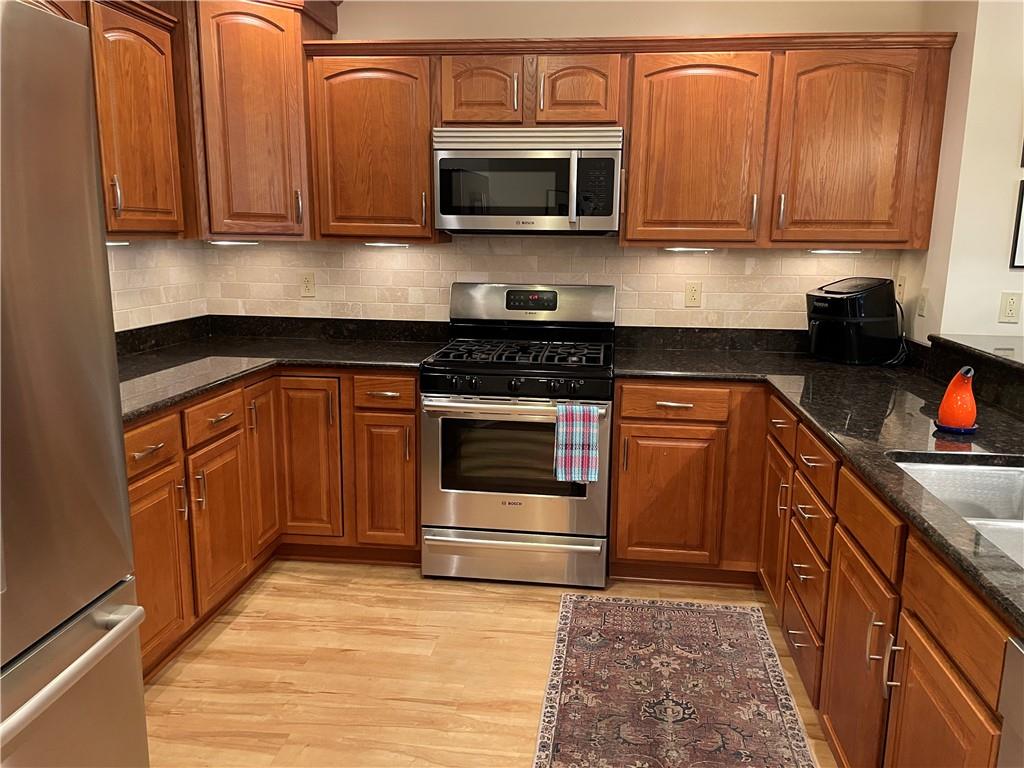 295 Market Street, Unit 123 Beaver, PA 15009 - Photo 8 of 27 a kitchen with stainless steel appliances granite countertop a stove microwave and sink