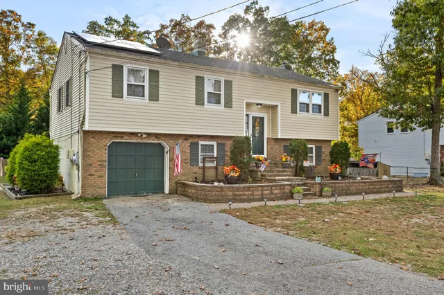 a view of a house with a yard and sitting area