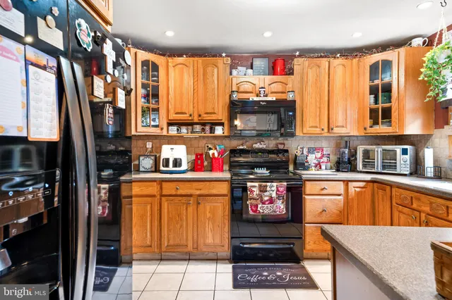 a kitchen with stainless steel appliances a stove a sink and a microwave