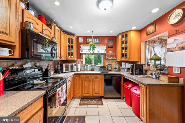 a kitchen with stainless steel appliances granite countertop sink stove and cabinets