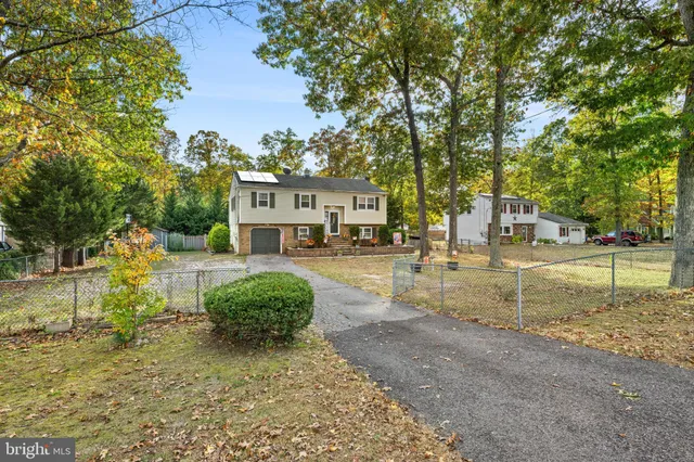 a view of a street with a building and a street sign