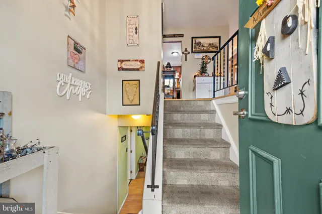 a view of an entryway with wooden floor