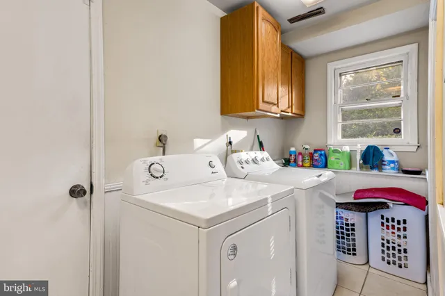 a view of a backyard with a tree and wooden fence