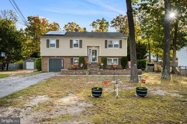 a view of a house with backyard porch and sitting area