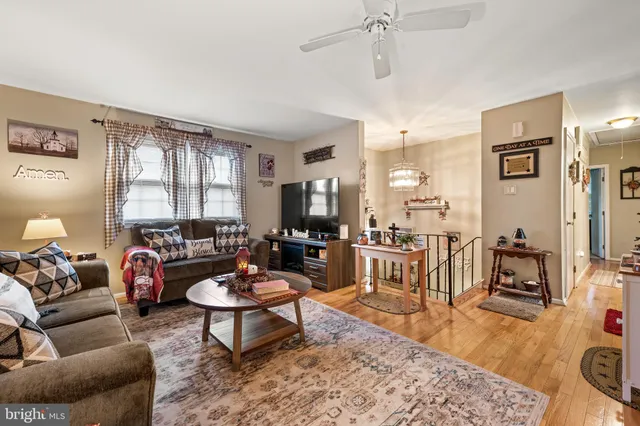 a living room with furniture a rug and a chandelier