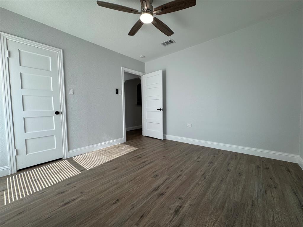 2909 Alexander Avenue Waco, TX 76708 - Photo 20 of 27 Unfurnished bedroom featuring dark wood finished floors and ceiling fan