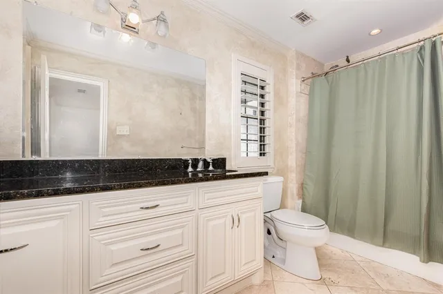 a bathroom with a sink a toilet a mirror and shower