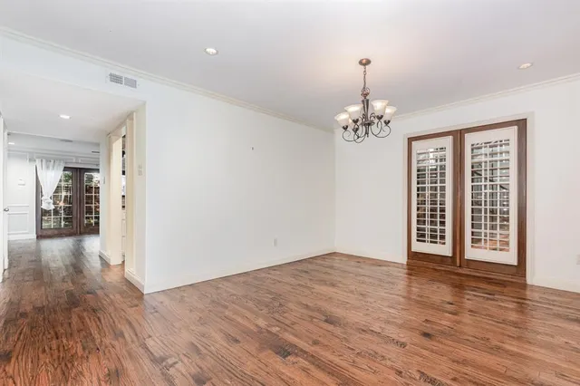 a view of a room with wooden floor and a window