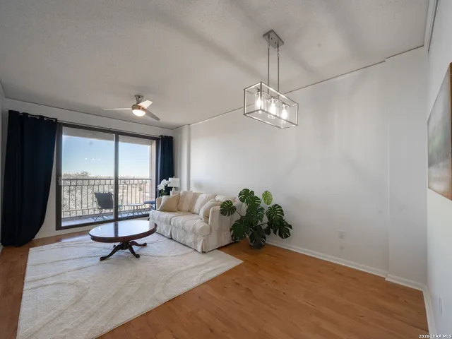 a living room with furniture and a floor to ceiling window