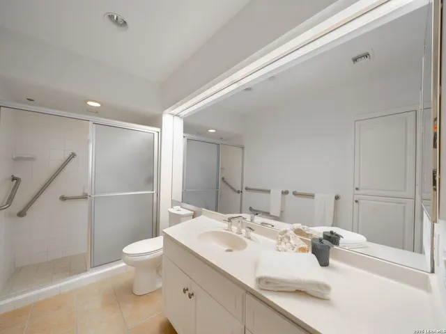 a bathroom with a sink toilet and shower