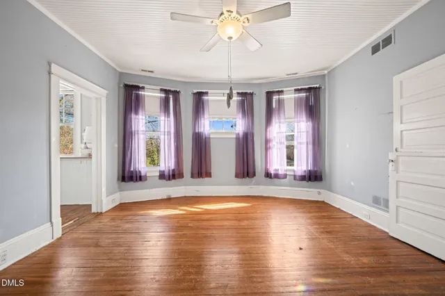 a view of room with window and wooden floor