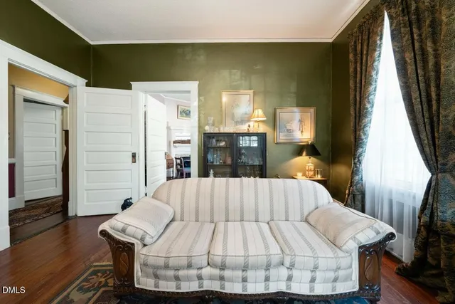 a bed sitting in a bedroom next to a window