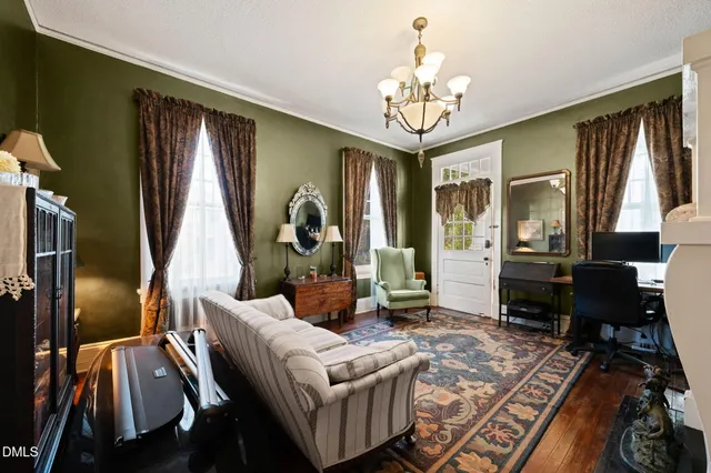 a living room with furniture and a chandelier