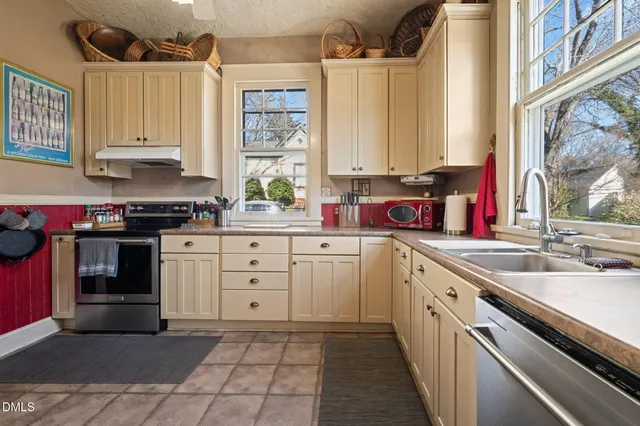 a kitchen with a sink stove and cabinets