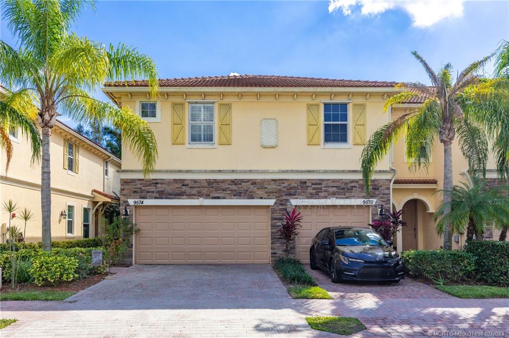9574 Southwest Purple Martin Way Stuart, FL 34997 - Photo 1 of 32 a view of a house with a patio and a yard