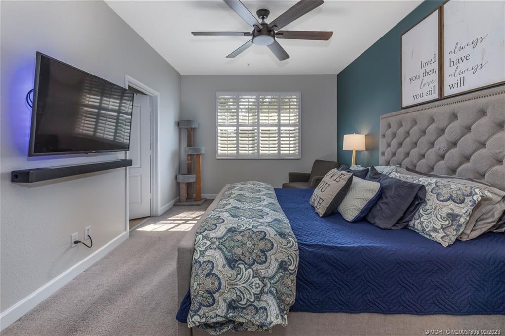 9574 Southwest Purple Martin Way Stuart, FL 34997 - Photo 14 of 32 a bedroom with a bed and window