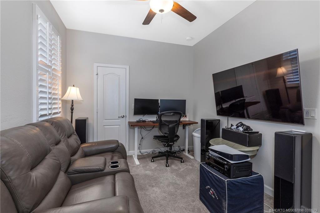 9574 Southwest Purple Martin Way Stuart, FL 34997 - Photo 18 of 32 a living room with furniture and a flat screen tv
