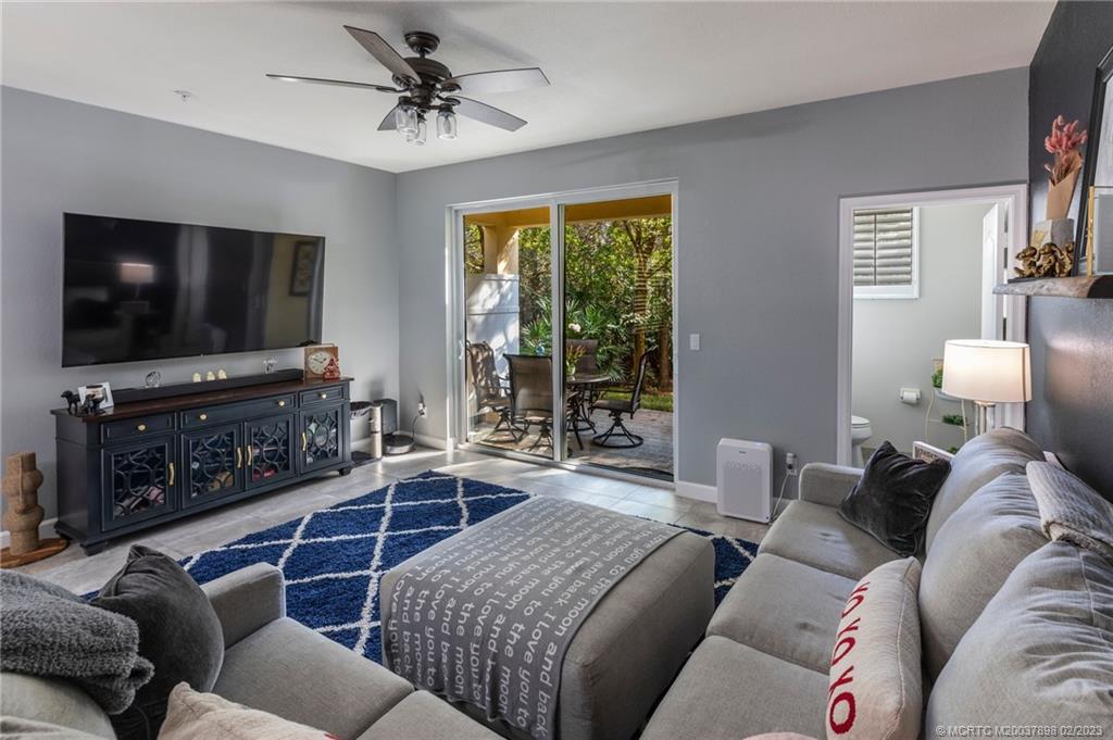 9574 Southwest Purple Martin Way Stuart, FL 34997 - Photo 24 of 32 a living room with furniture and a flat screen tv
