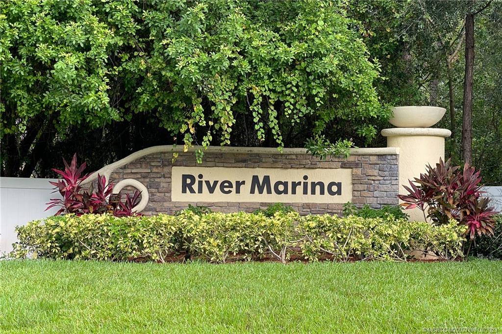 9574 Southwest Purple Martin Way Stuart, FL 34997 - Photo 27 of 32 a sign that is sitting on a lush green field