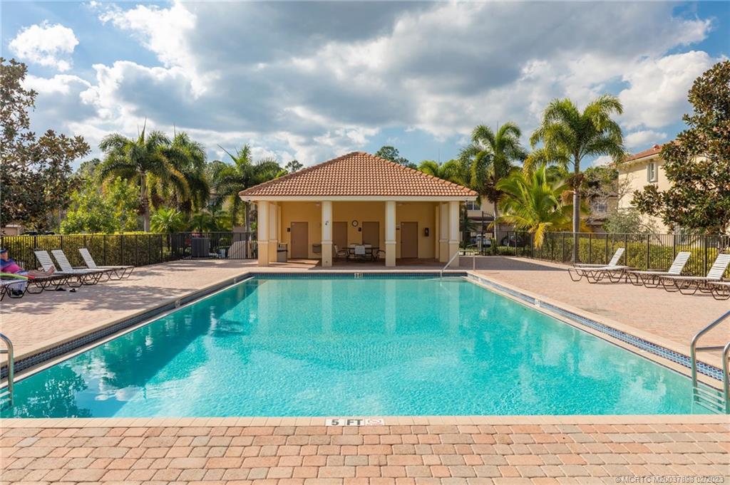 9574 Southwest Purple Martin Way Stuart, FL 34997 - Photo 29 of 32 a view of swimming pool with a garden