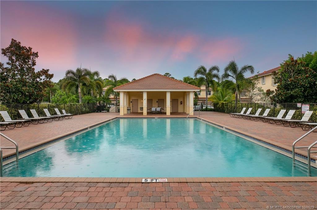 9574 Southwest Purple Martin Way Stuart, FL 34997 - Photo 30 of 32 a view of a swimming pool with a yard