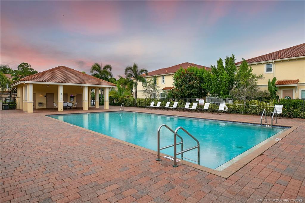 9574 Southwest Purple Martin Way Stuart, FL 34997 - Photo 31 of 32 a view of swimming pool and chairs in patio