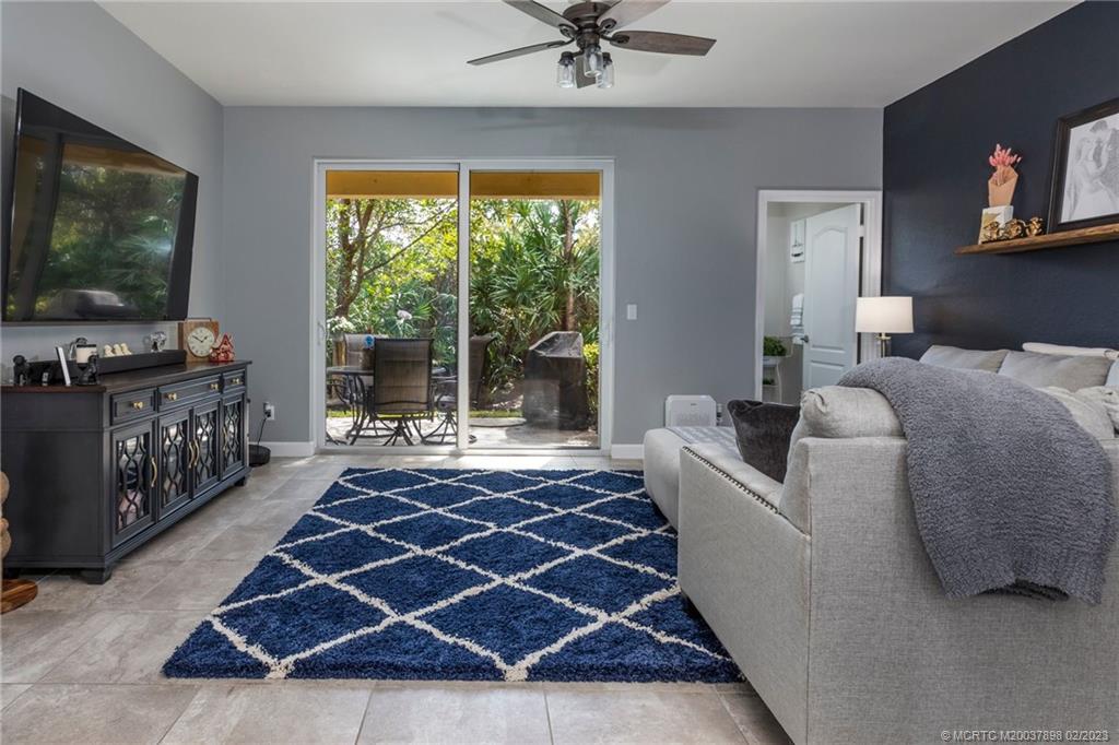 9574 Southwest Purple Martin Way Stuart, FL 34997 - Photo 5 of 32 a living room with furniture and a flat screen tv