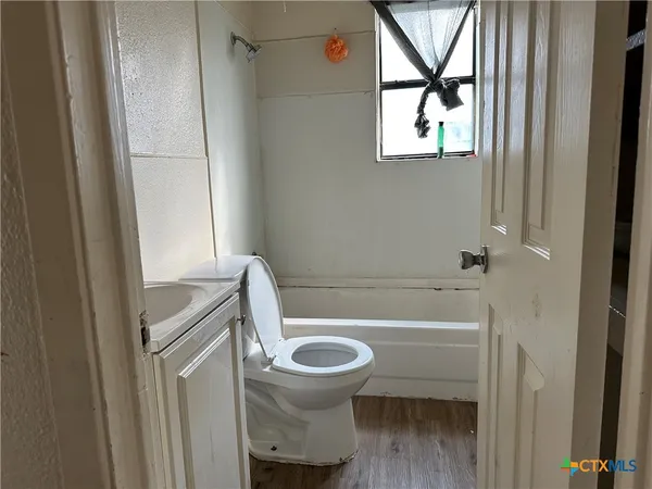 a bathroom with a toilet and a bathtub