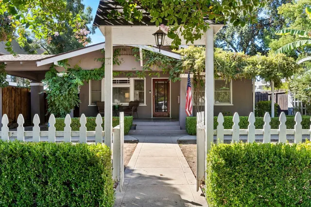 a view of a chair and tables in patio with a small yard