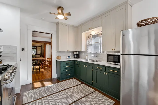 a kitchen with stainless steel appliances granite countertop a refrigerator and a sink