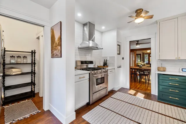 a kitchen with stainless steel appliances granite countertop a stove and a refrigerator