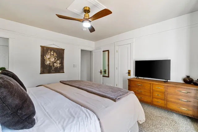 a bedroom with a bed and a flat screen tv