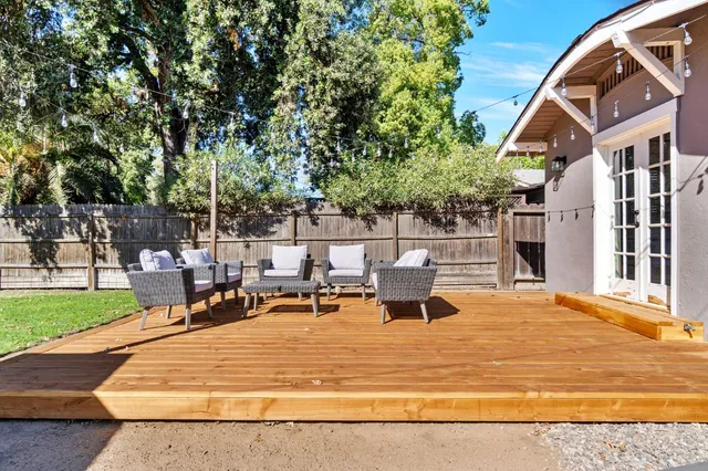 a view of a house with backyard and sitting area