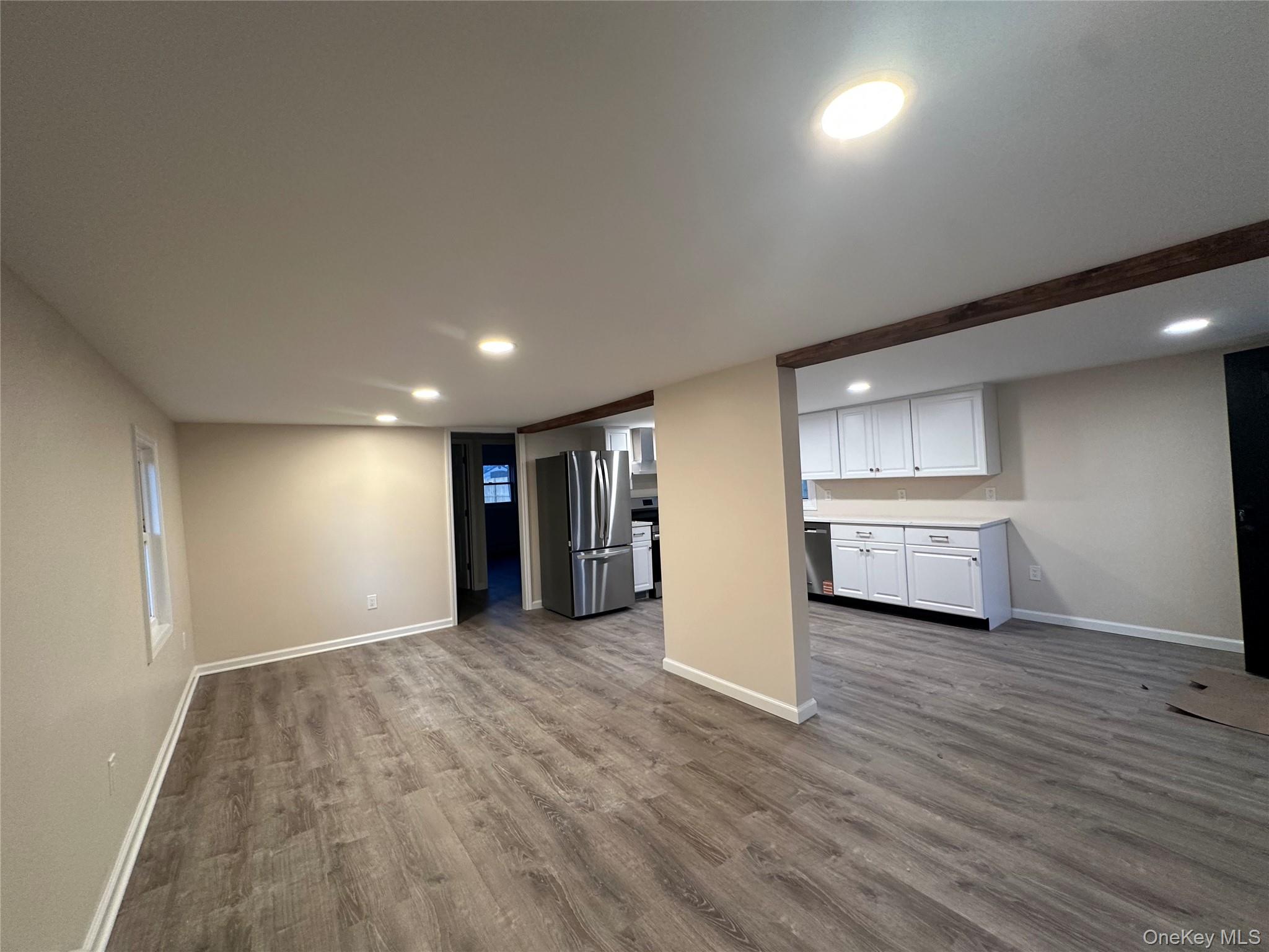 103 Sunrise Trail Wallkill, NY 12589 - Photo 12 of 24 Unfurnished living room featuring dark wood-style flooring and recessed lighting