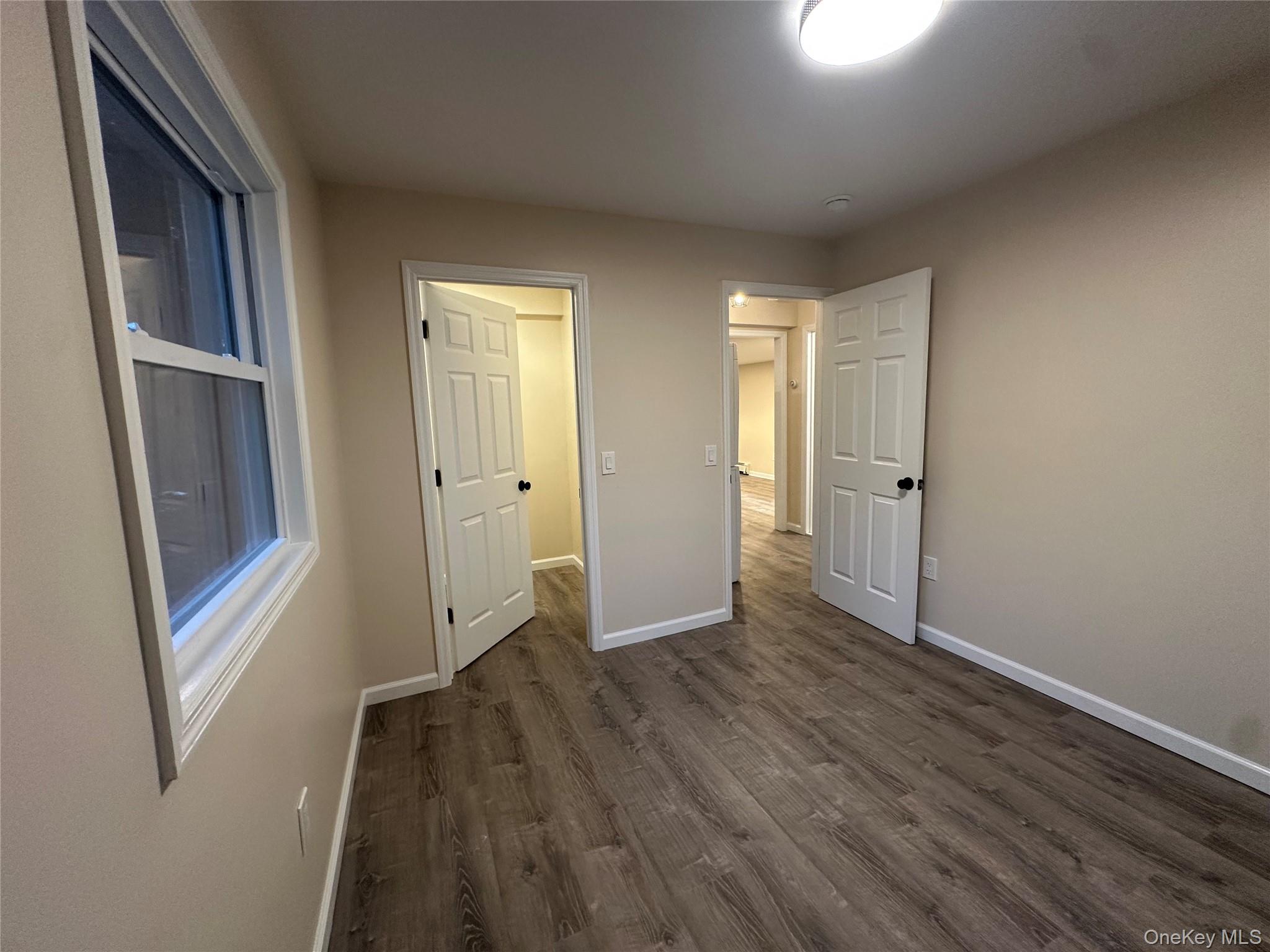 103 Sunrise Trail Wallkill, NY 12589 - Photo 18 of 24 Unfurnished bedroom featuring dark wood-style floors and baseboards