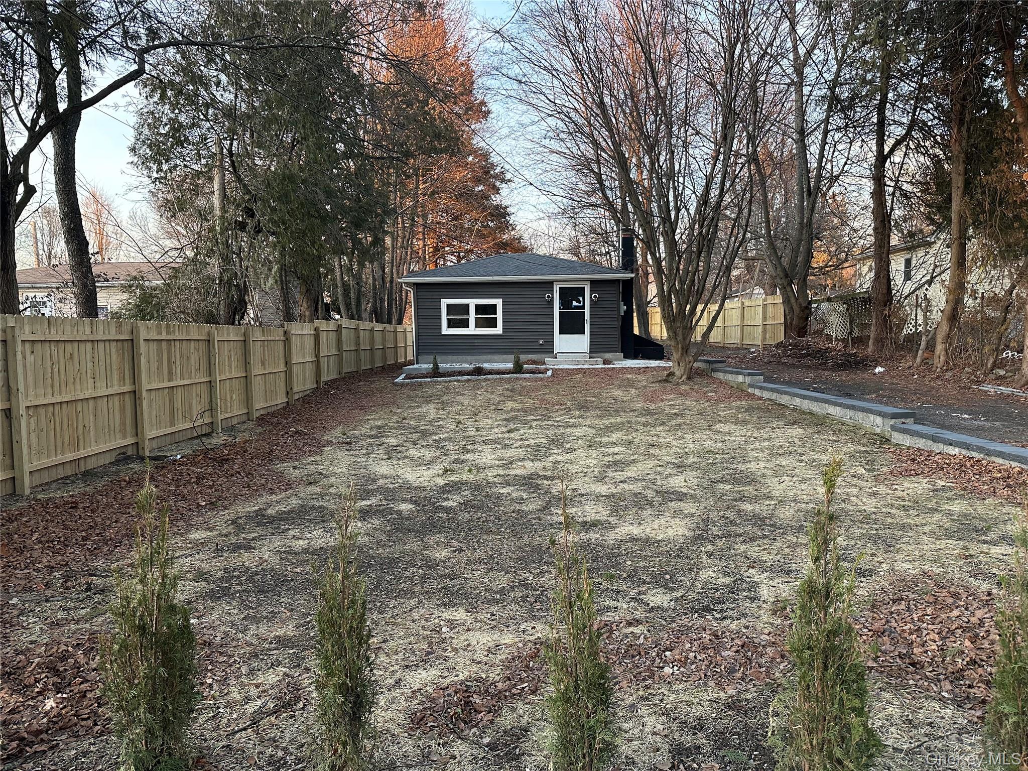 103 Sunrise Trail Wallkill, NY 12589 - Photo 2 of 24 Rear view of property with a fenced backyard