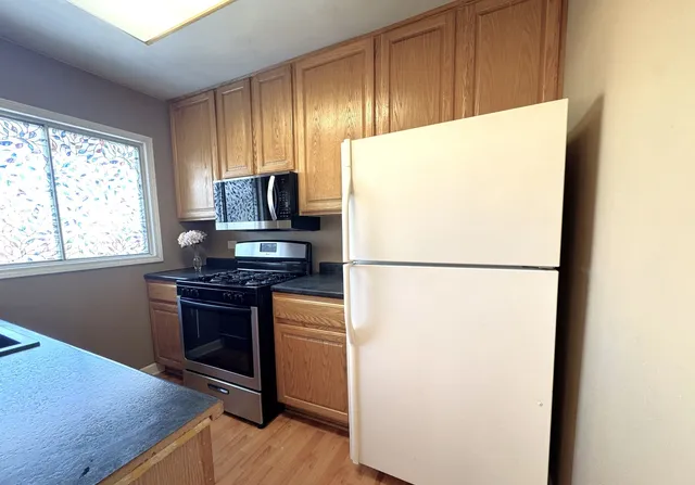 a kitchen with a refrigerator and a stove