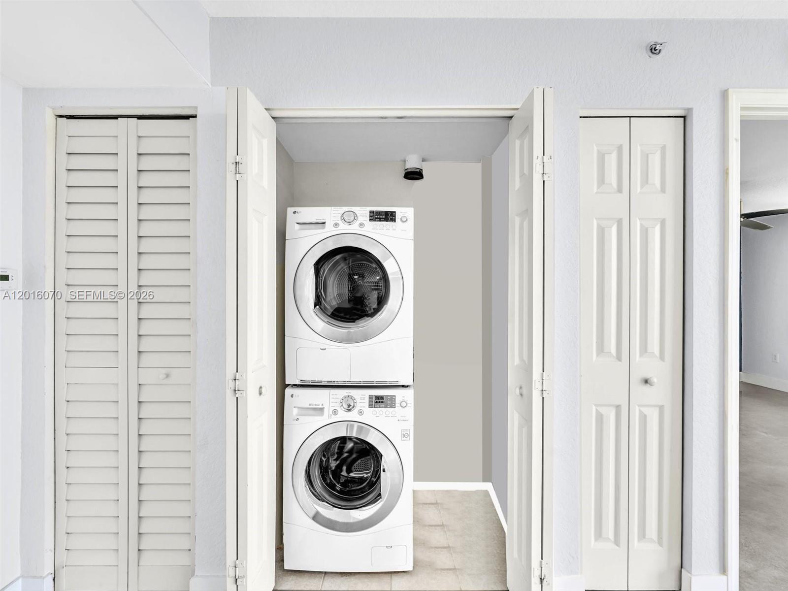 816 Northwest 11th Street, Unit 1208 Miami, FL 33136 - Photo 12 of 49 a view of a hallway with washer and dryer
