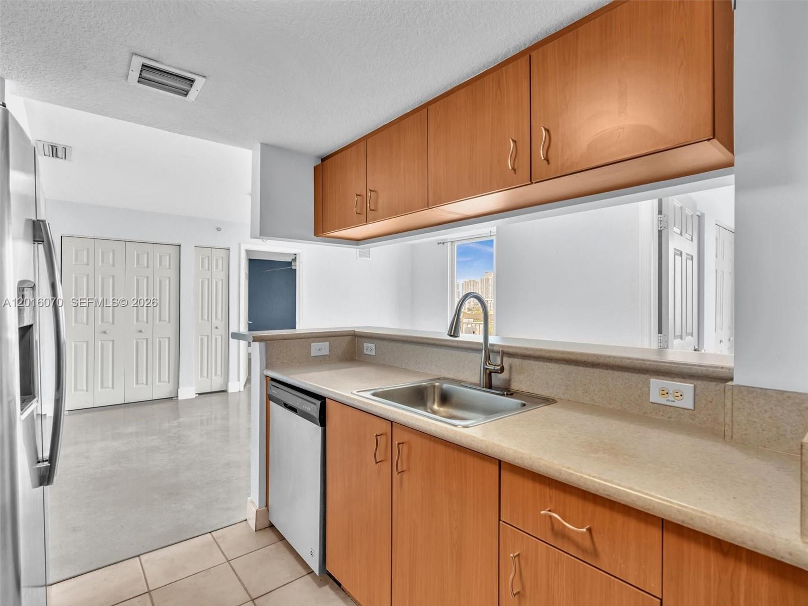 816 Northwest 11th Street, Unit 1208 Miami, FL 33136 - Photo 15 of 49 a kitchen with stainless steel appliances granite countertop a sink and cabinets with wooden floor