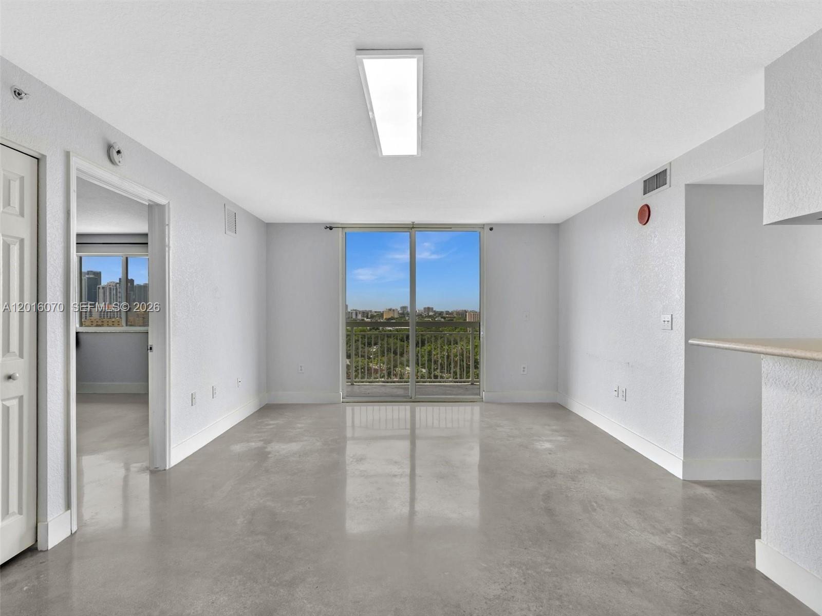 816 Northwest 11th Street, Unit 1208 Miami, FL 33136 - Photo 2 of 49 an empty room with a empty space and windows