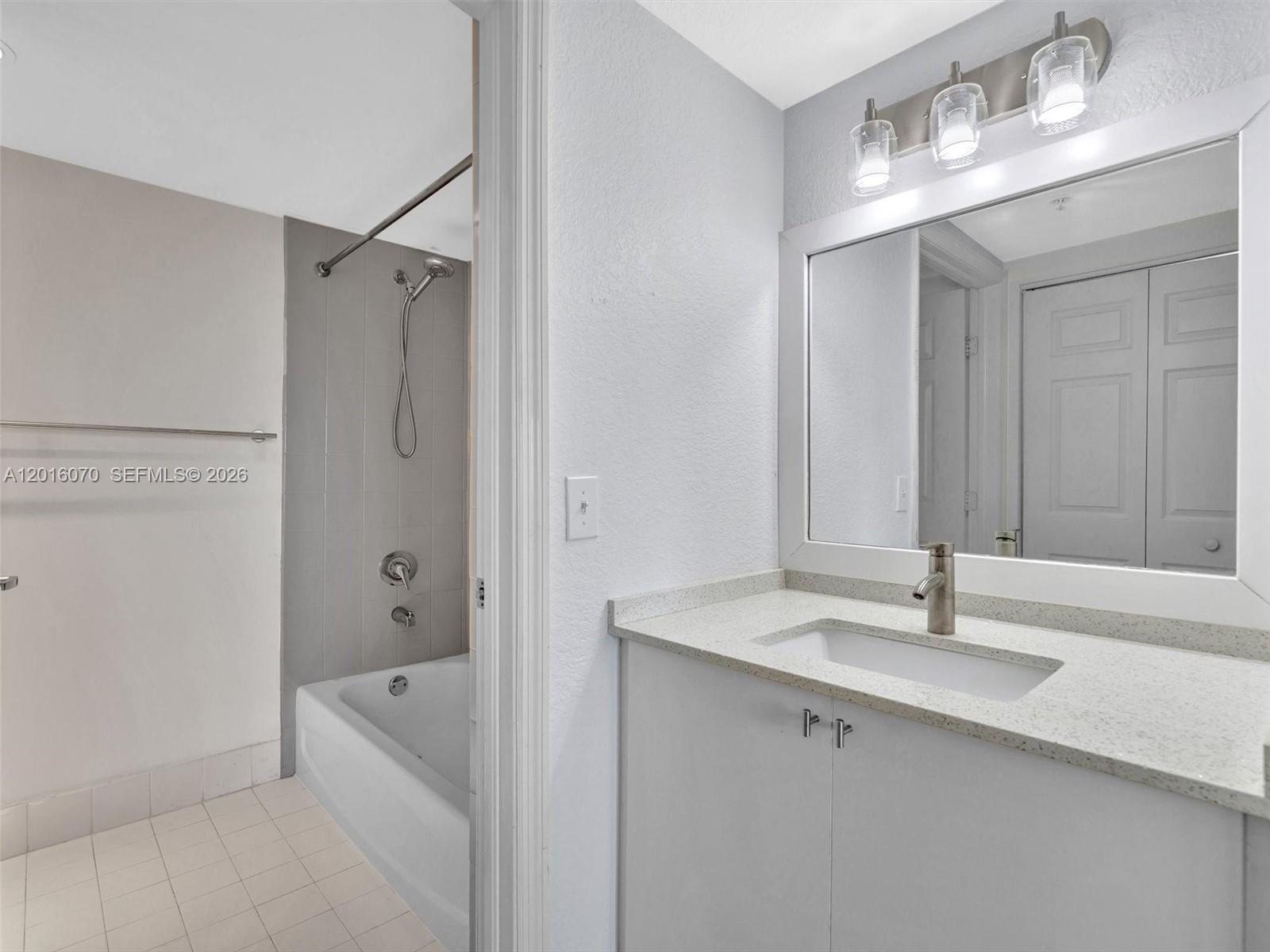 816 Northwest 11th Street, Unit 1208 Miami, FL 33136 - Photo 22 of 49 a bathroom with a sink double vanity and tub