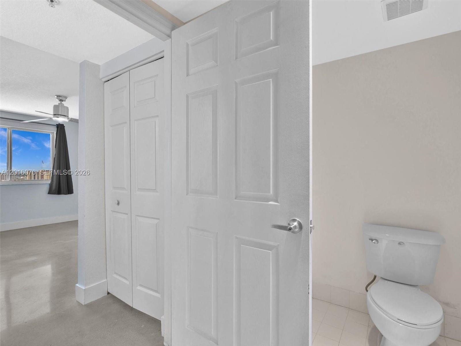 816 Northwest 11th Street, Unit 1208 Miami, FL 33136 - Photo 23 of 49 a white toilet sitting next to a bathroom sink