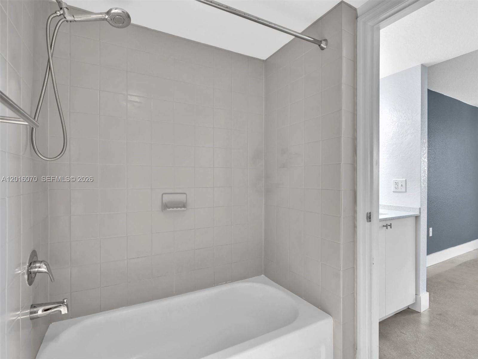 816 Northwest 11th Street, Unit 1208 Miami, FL 33136 - Photo 24 of 49 a bathroom with a white bath tub and a shower