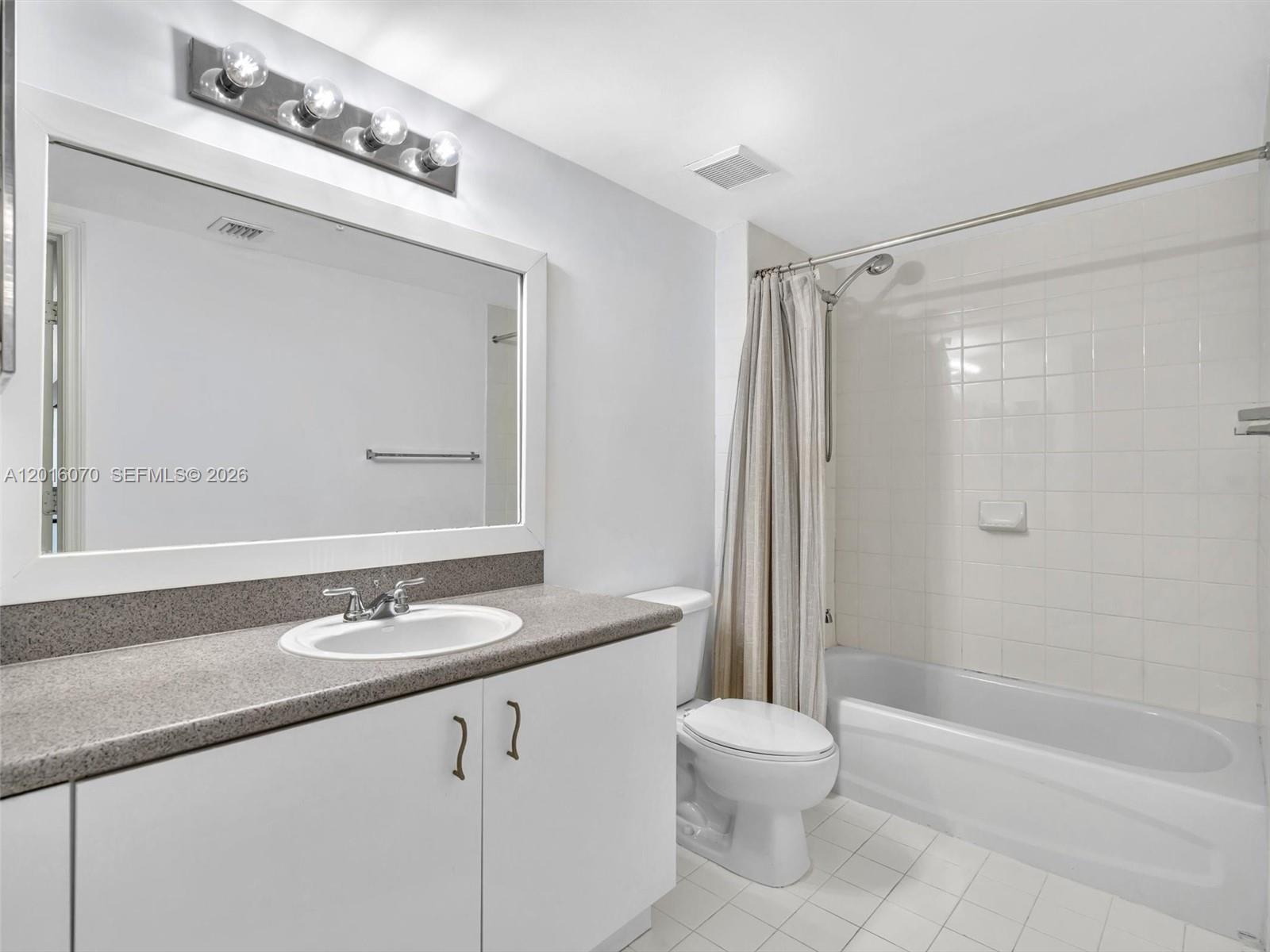 816 Northwest 11th Street, Unit 1208 Miami, FL 33136 - Photo 29 of 49 a bathroom with a sink a toilet and shower