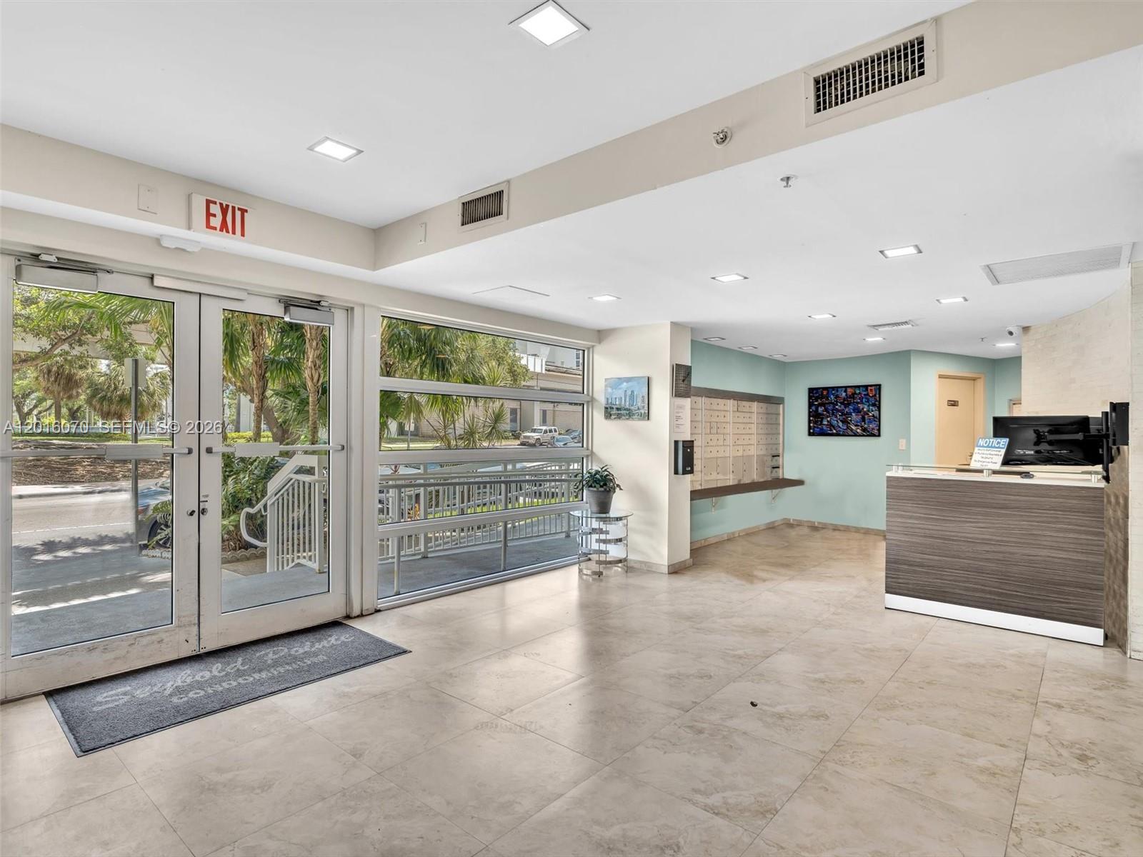 816 Northwest 11th Street, Unit 1208 Miami, FL 33136 - Photo 37 of 49 a view of a hall with kitchen and front door