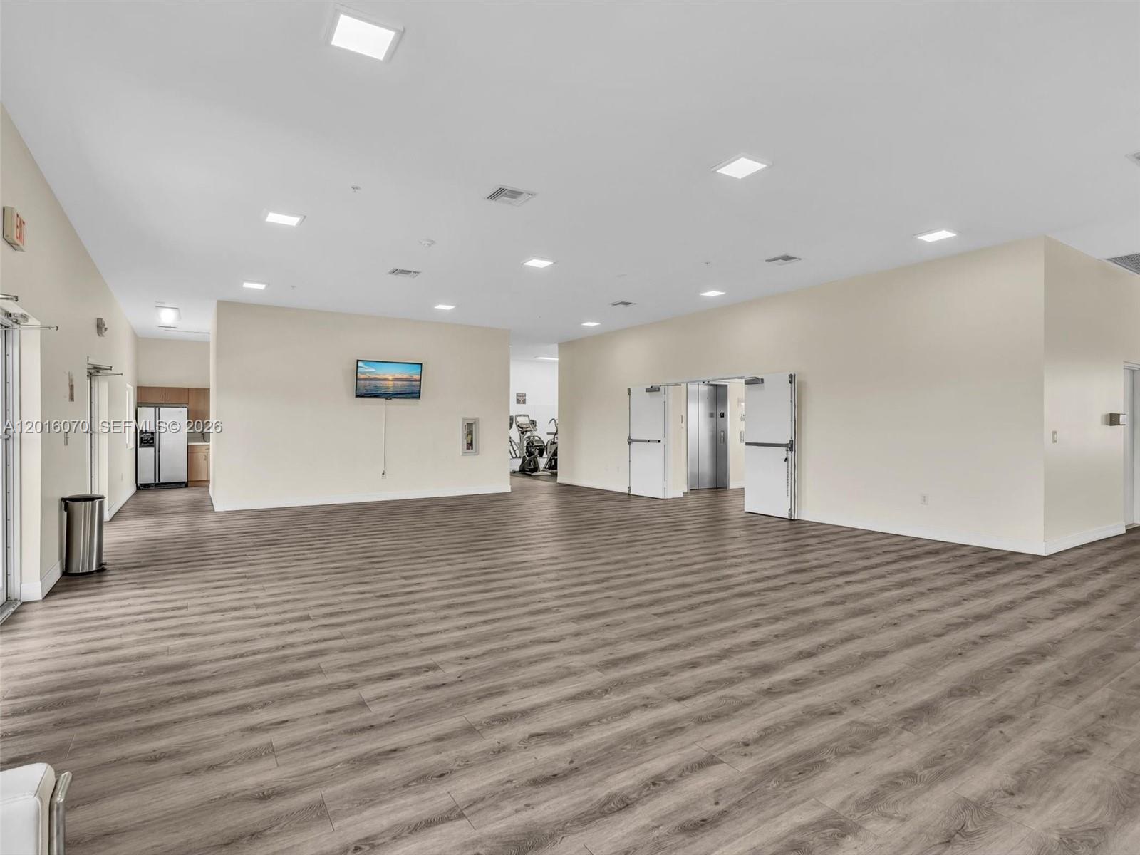 816 Northwest 11th Street, Unit 1208 Miami, FL 33136 - Photo 42 of 49 a view of empty room with wooden floor